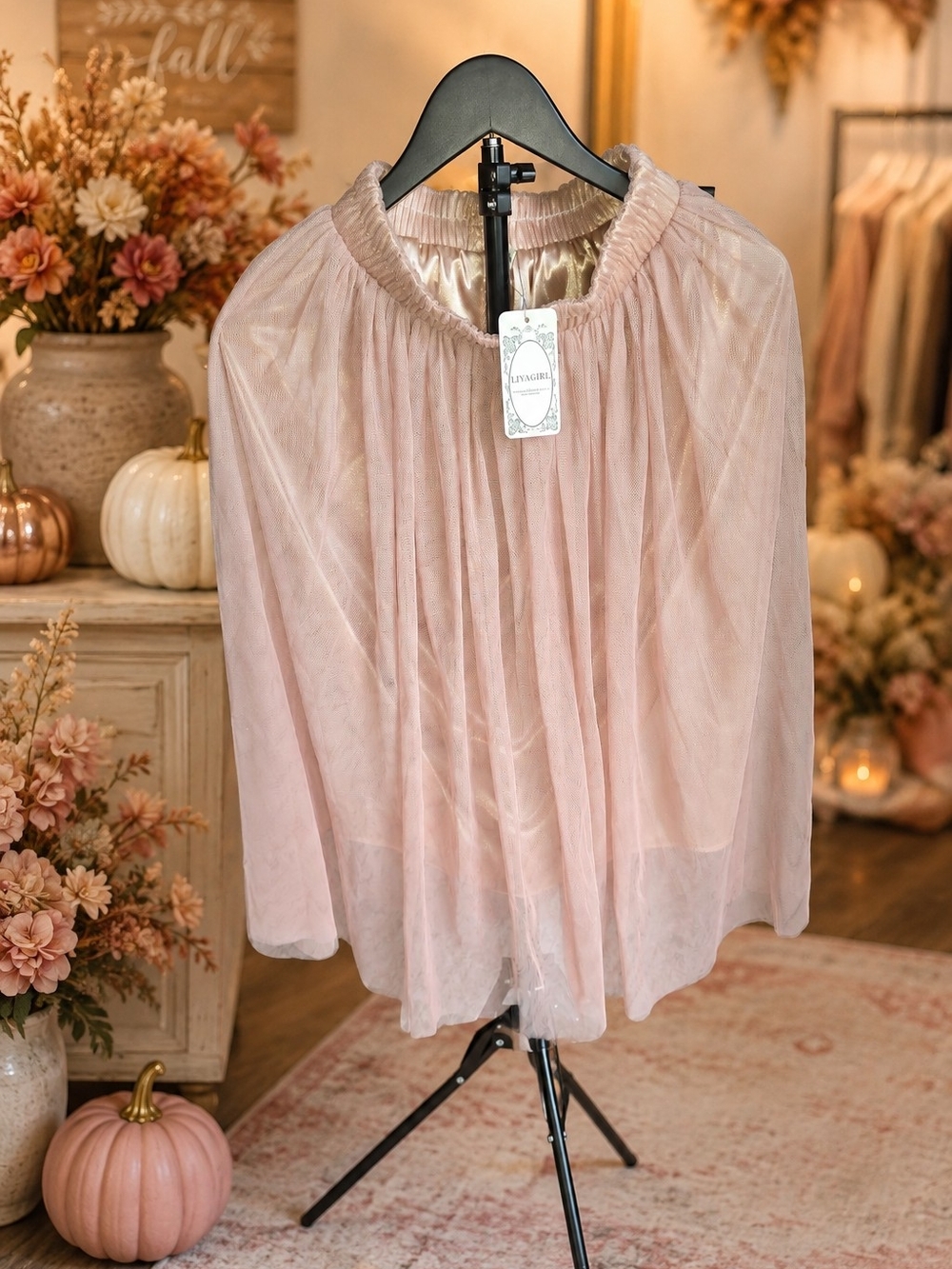 This light pink Liva Girl tulle overlay skirt features an elasticized waistband